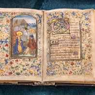 Ancient bible open on a page with a drawn image