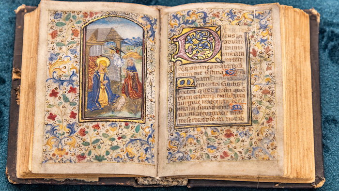 Ancient bible open on a page with a drawn image