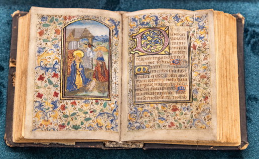 Ancient bible open on a page with a drawn image