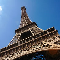 A photo of the Eiffel Tower with blue sky in background