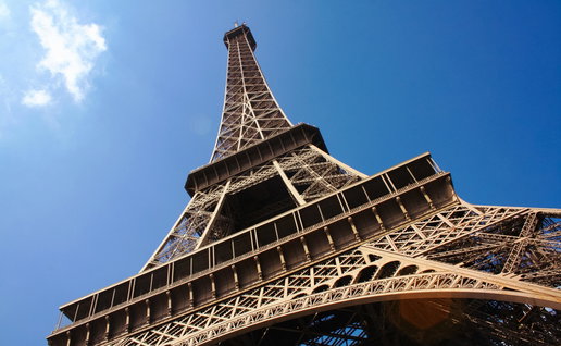 A photo of the Eiffel Tower with blue sky in background
