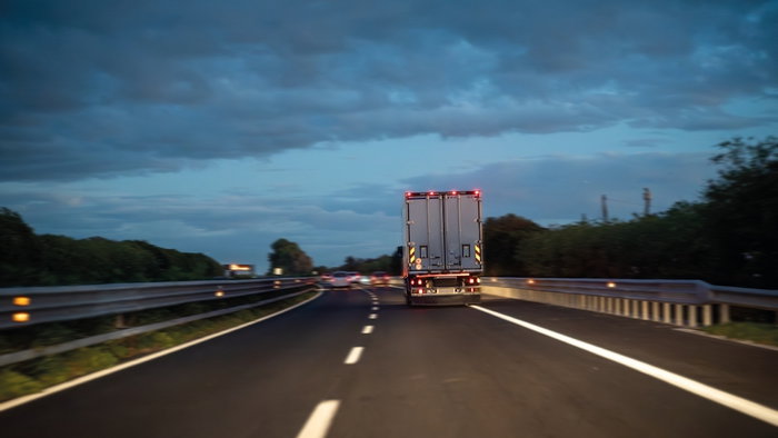 Trucks on the motorway, night transport of goods.