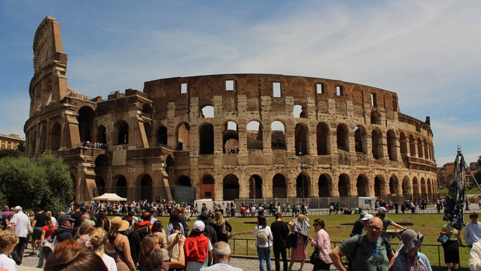 The colosseum surrounded by tourists