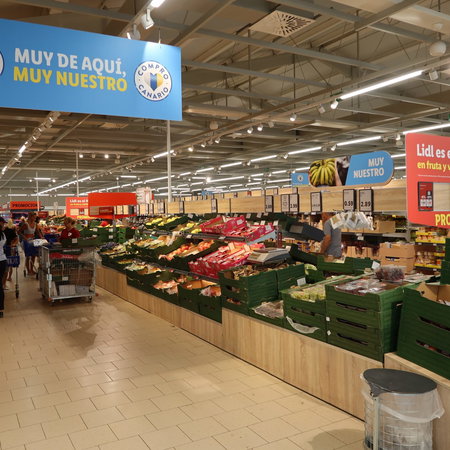 Inside of a supermarket in the fruit and vegetable aisle
