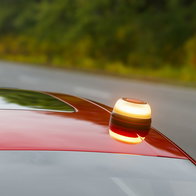 V16 Emergency beacon on the roof of a red car