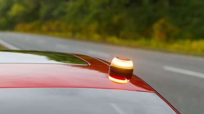 V16 Emergency beacon on the roof of a red car