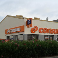 The orange logo of a Consum supermarket in Spain