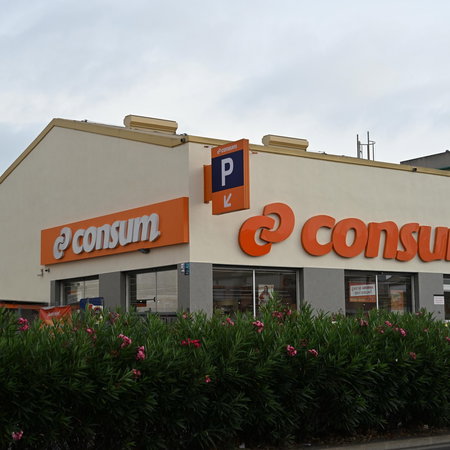 The orange logo of a Consum supermarket in Spain
