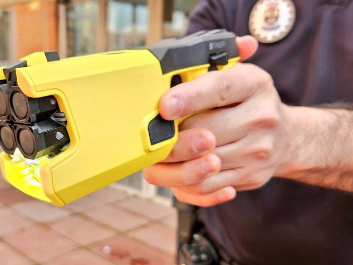 Local police carrying taser electronic pistols.