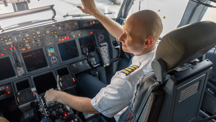 A pilot in a white shirt with gold captain’s stripes reaches towards the overhead panel in an airliner cockpit, with screens and controls in front of him. The caption is general and doesn’t claim the photo shows any real pilot or airline, because it’s stock. The image is landscape, so it fits the spec. I’ve put the caption and credit into the Description line of the print .docx in Issue 2156 (replacing the “to be confirmed” placeholder). When you save the image into that folder, a name like pilot cockpit PAPER.jpg follows your convention. Claude is AI and can make mistakes.