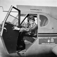 Amelia Earhart sitting in the cockpit of an aircraft