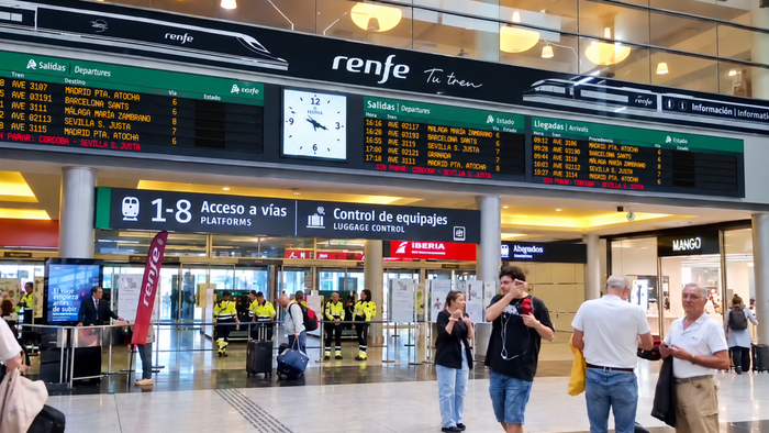 Scene from Maria Zambrano station in Malaga with train times boards