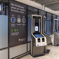 Biometric self-service kiosks for non-EU travellers at a European airport.