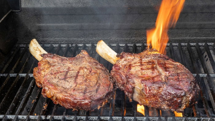 grilled rib eye steaks on bbq