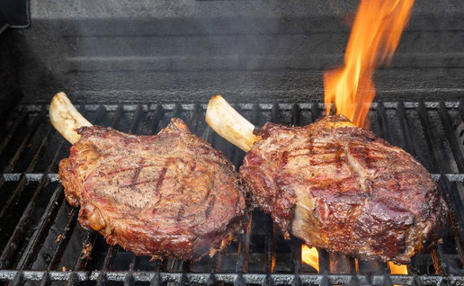grilled rib eye steaks on bbq