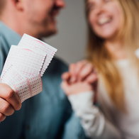 Cropped view of a happy couple after winning on the lottery