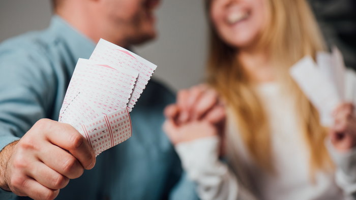 Cropped view of a happy couple after winning on the lottery