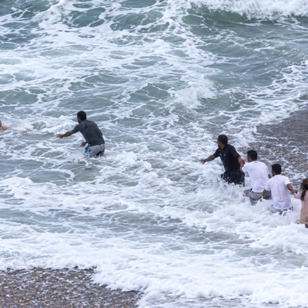 Passersby race to rescue of woman washed out to sea.