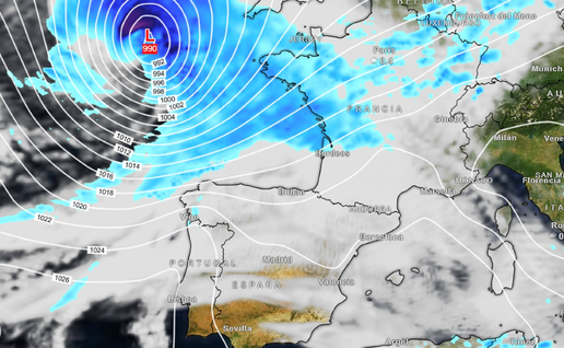 Weather map of western Europe showing a deep low-pressure system marked L 990 to the north-west of France, ringed by curved white pressure lines, with blue bands of rain over the sea, the English Channel and France, and mostly cloudy but dry skies over Spain and Portugal.