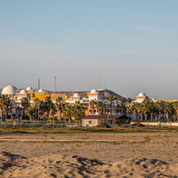 Seafront homes and palm trees beside the beach at Vera Playa in Almería, Spain
