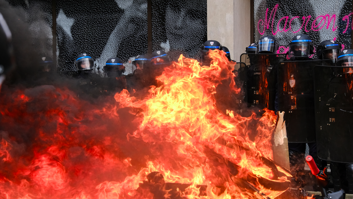 Riot Police barricade themselves together during civil unrest in France