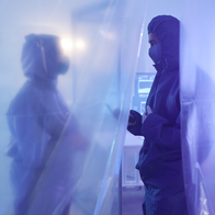 Two doctors in full protective suites in a quarantined area