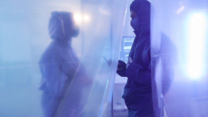 Two doctors in full protective suites in a quarantined area
