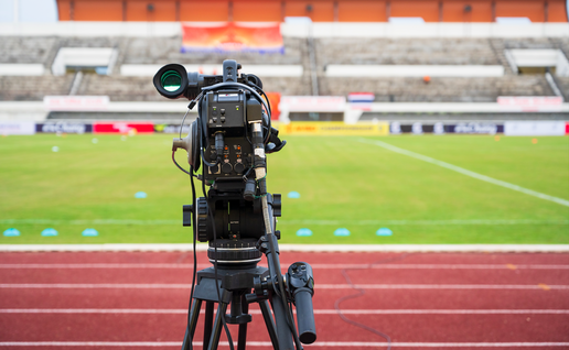 A camera facing a football pitch ready to record footage of a match
