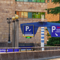An entrance to an underground parking with two 'P' signs on either side of the road