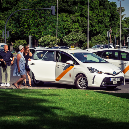 Tourists getting into a Taxi in Sevilla, Spain