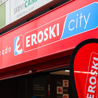 The entrance of an Eroski city supermarket with the logo over head