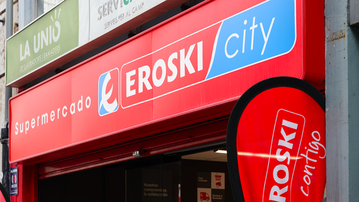 The entrance of an Eroski city supermarket with the logo over head