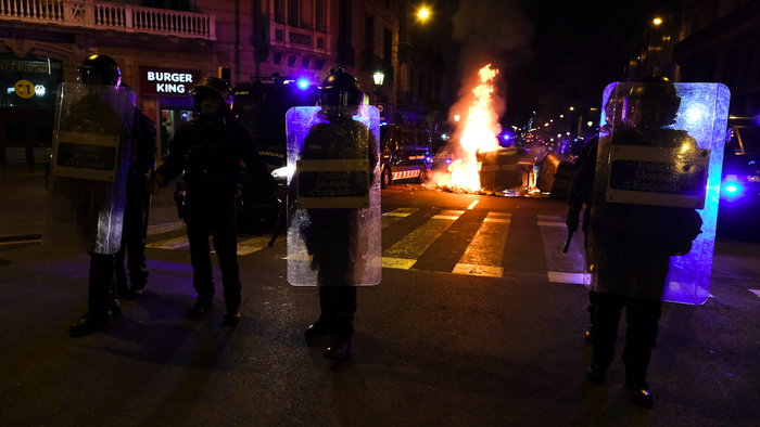 Protesters setting fire on rubbish containers during a riot in Barcelona