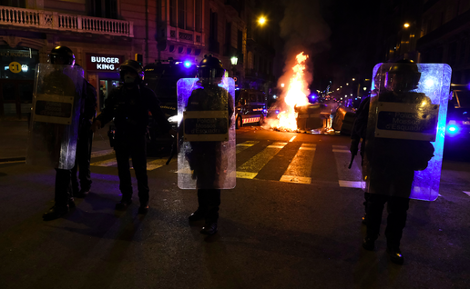 Protesters setting fire on rubbish containers during a riot in Barcelona