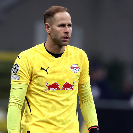 Goalkeeper Péter Gulácsi in a yellow RB Leipzig kit and red gloves during a Champions League match