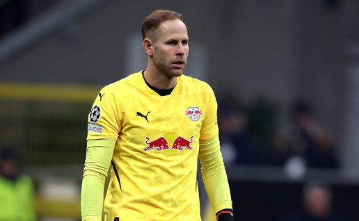 Goalkeeper Péter Gulácsi in a yellow RB Leipzig kit and red gloves during a Champions League match