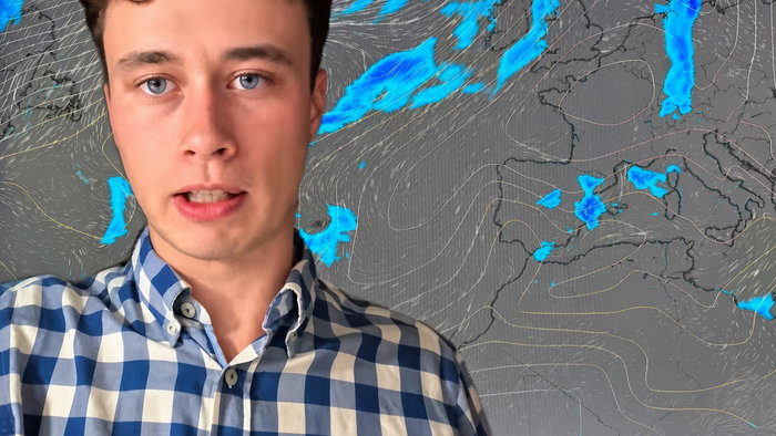Young man in blue-and-white checkered shirt in front of a weather map of Europe.