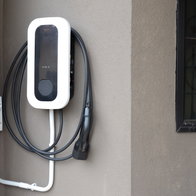 Electric Vehicle Charging Station Mounted on Exterior House Wall