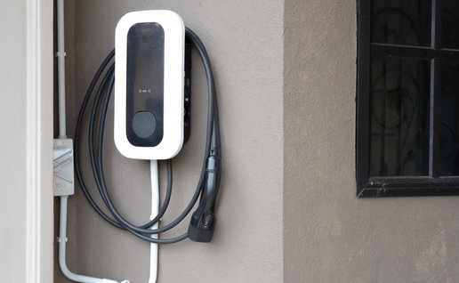 Electric Vehicle Charging Station Mounted on Exterior House Wall