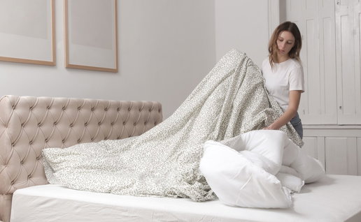 Woman stripping bed linen