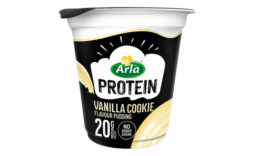 A black and white pot of Arla Protein vanilla cookie flavour pudding with a cream-coloured swirl design, marked 20g protein and no added sugar.
