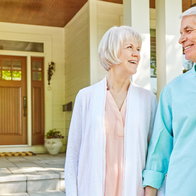 Senior couple standing outside their home in Spain