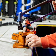 Person servicing a bicycle in a garage