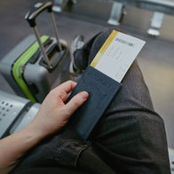 Passenger holding passport and boarding pass at airport