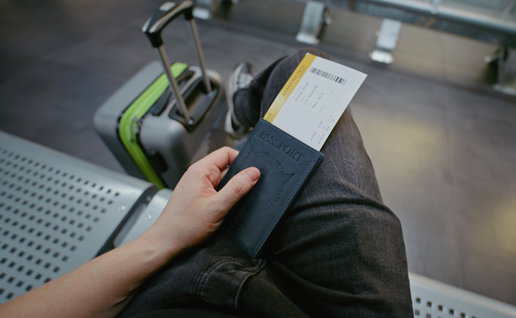 Passenger holding passport and boarding pass at airport