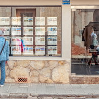 A man looking for where to live in an estate agency in Spain