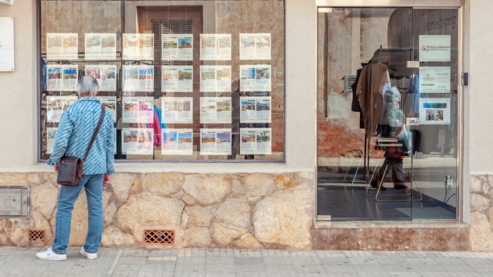 A man looking for where to live in an estate agency in Spain
