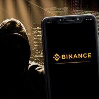 Binance logo on a smartphone screen and a dark figurer wearing a hoodie representing a hacker next to it.