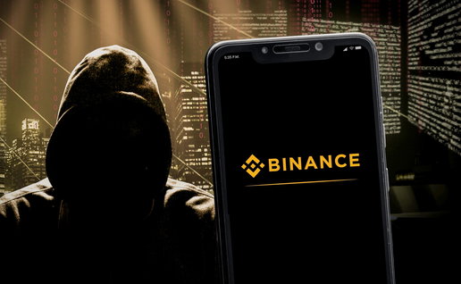 Binance logo on a smartphone screen and a dark figurer wearing a hoodie representing a hacker next to it.