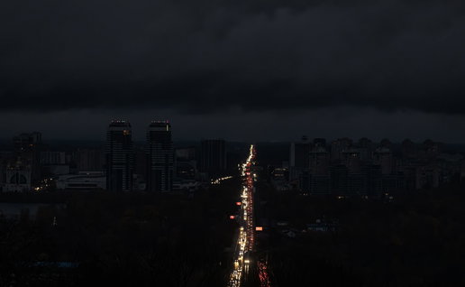 A city during a blackout where only the lights of the cars on the are visible
